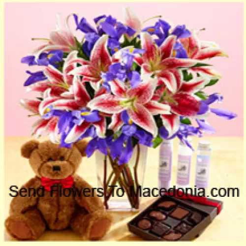 Pink Lilies And Assorted Purple Flowers Arranged Beautifully In A Glass Vase, A Cute 12 Inches Tall Brown Teddy Bear And An Imported Box Of Chocolates